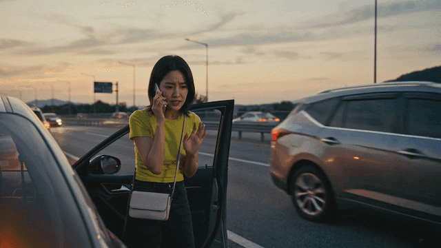 Woman making a phone call on the highway