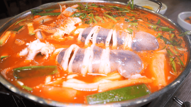 Spicy squid kalguksu boiling in pot