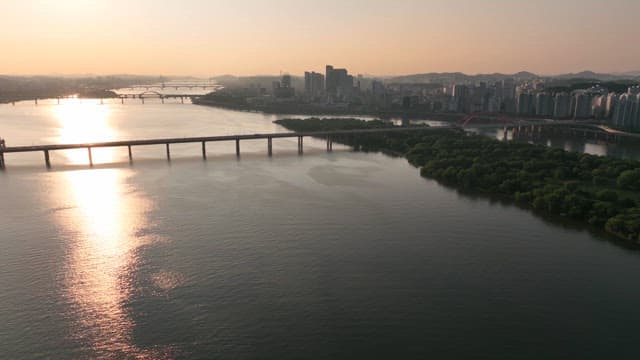 Sprawling city with tranquil river at sunset