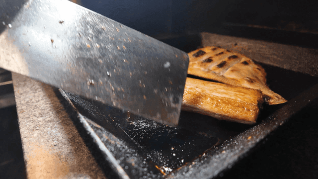 Flounder and cutlassfish grilling on hot iron plate