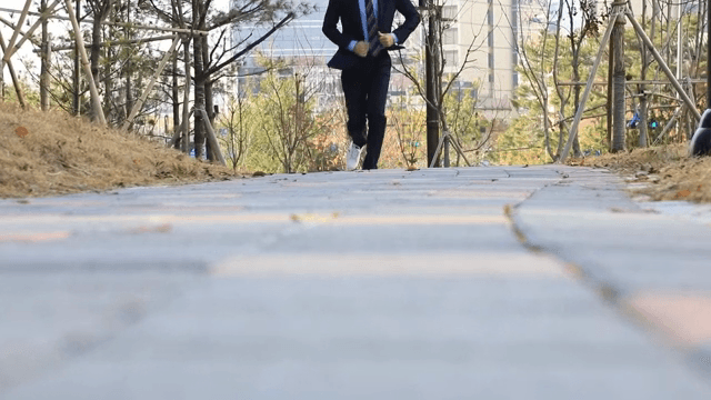 A person running quickly along a park trail