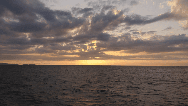 Sunset over the ocean with clouds