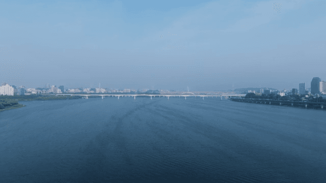 Wide river with long, stiff bridge visible