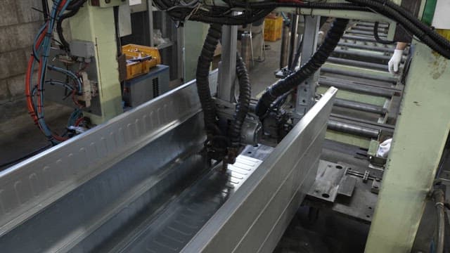 Metal sheet being processed in a factory