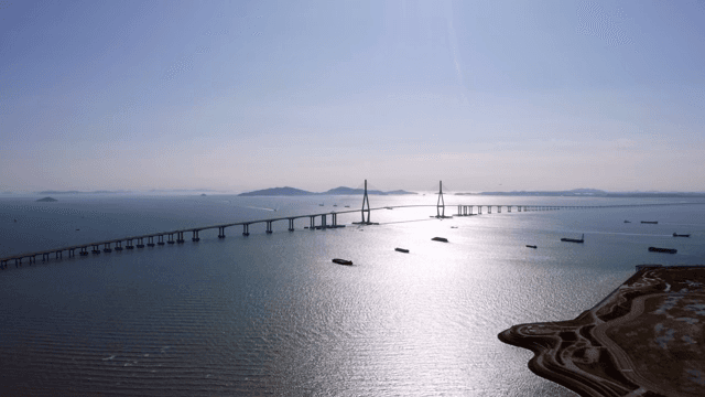Long bridges and boats on a calm, sunlit sea