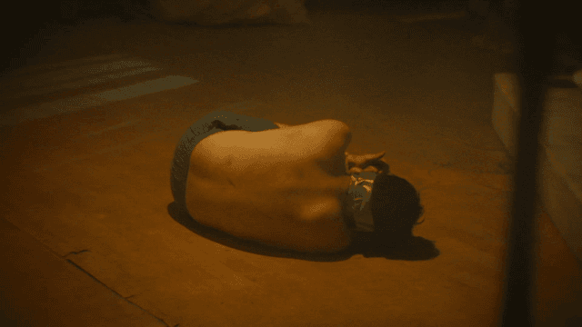 Person lying on floor with his limbs tied