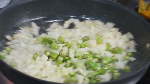 Stir-frying Onions and Asparagus in a Pan