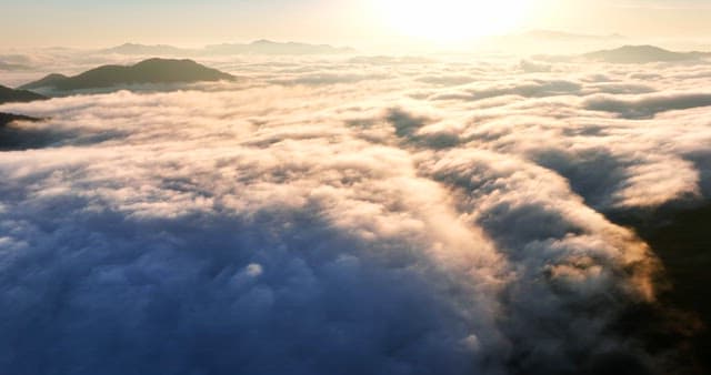 Sunrise over clouds and mountains