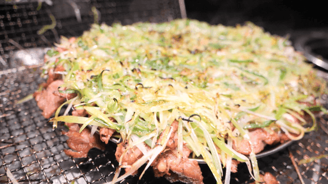 Grilled briquette bulgogi topped with fresh shredded green onions