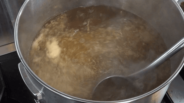 Stirring broth in a large pot