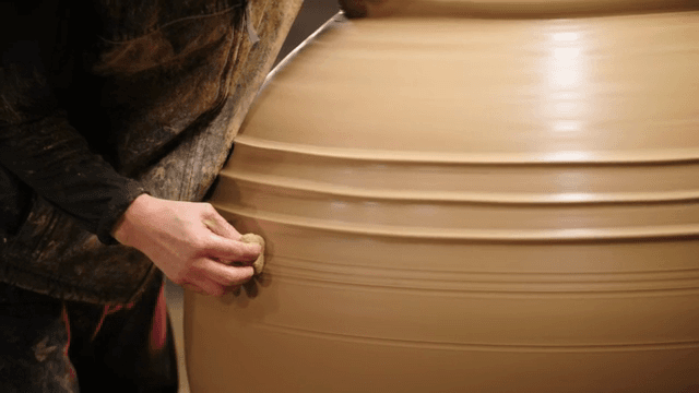 Craftsman making large pottery