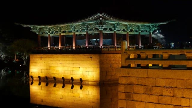 Illuminated traditional pavilion at night