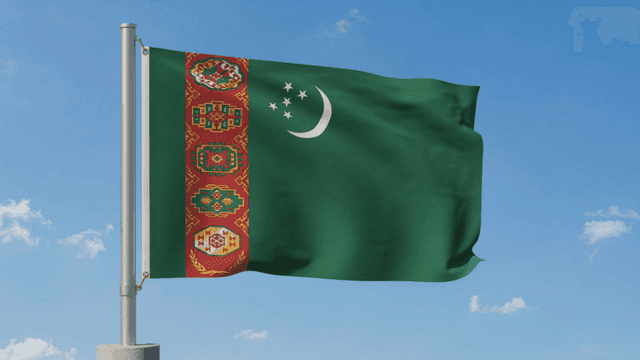 Turkmenistan flag fluttering under clear sky