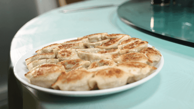 Golden brown fried dumplings on plate