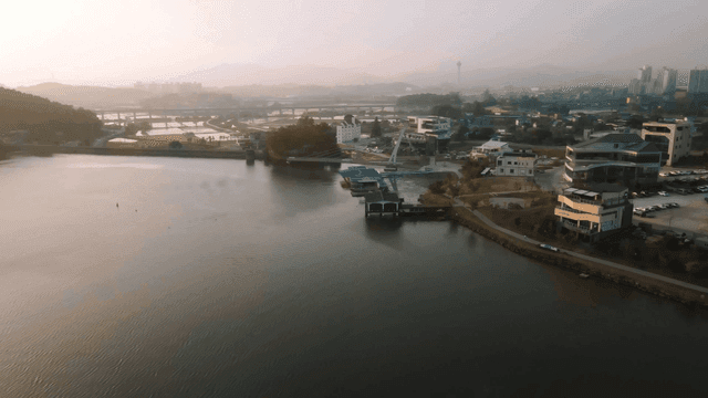 Sunrise over city landscape with river and buildings