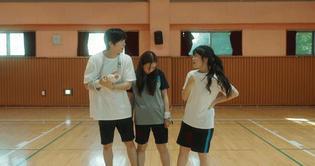 Three friends in a gym having a conversation