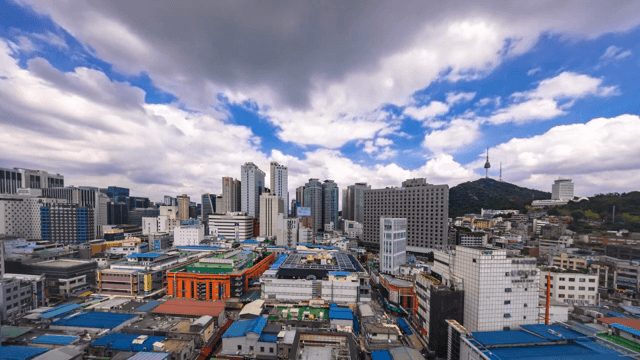 Bustling cityscape with a mountain and tower view