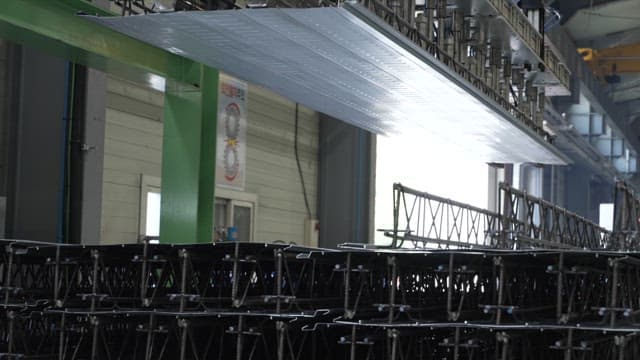 Metal sheets being processed in a factory