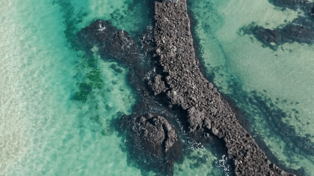 Clear turquoise sea with rocky breakwater