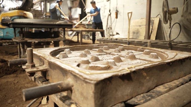 Workers shaping molds in a factory