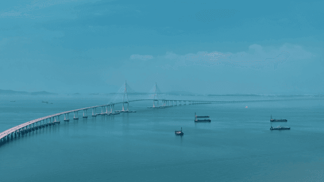 Long bridge over calm sea.