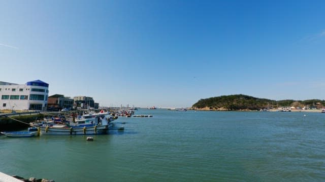 Peaceful day at a seaside village with boats docked and a clear blue sky