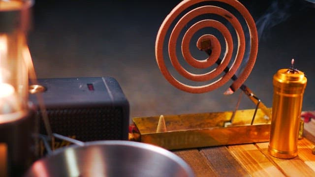 Lighting mosquito coil on a wooden table while camping