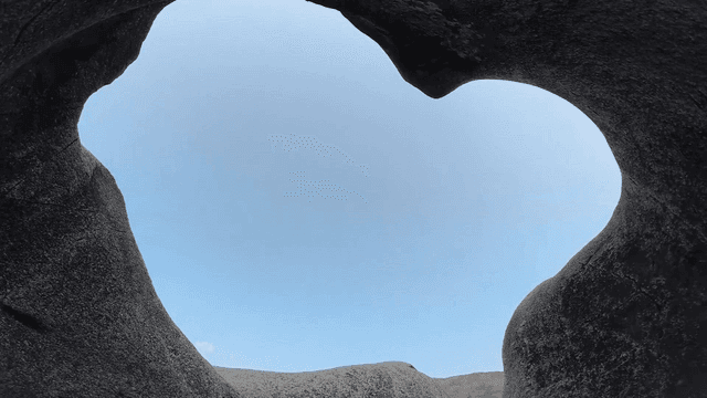 Curved rock formations under a clear sky