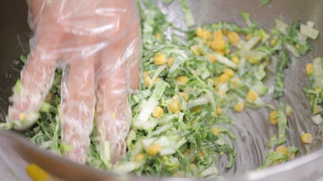 Fresh spring cabbage coleslaw with corn mixed with dressing