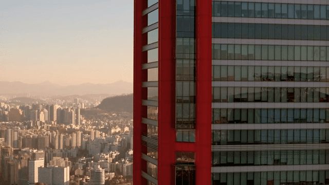 Cityscape with a red skyscraper and tower