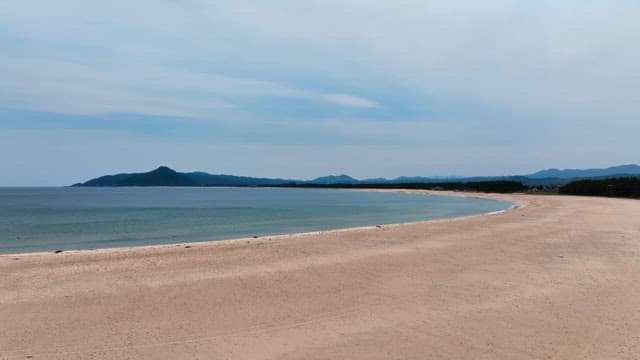 Serene beach with distant mountains