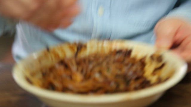 Mixing jajangmyeon in a bowl