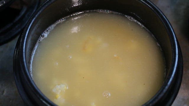 Putting chicken in a hot pot with tongs