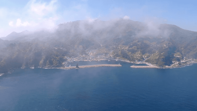 Coastal town surrounded by mountains