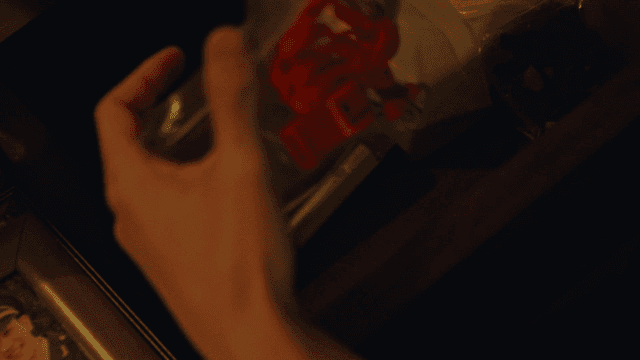 Hand taking from drawer an envelope-kept red whistle