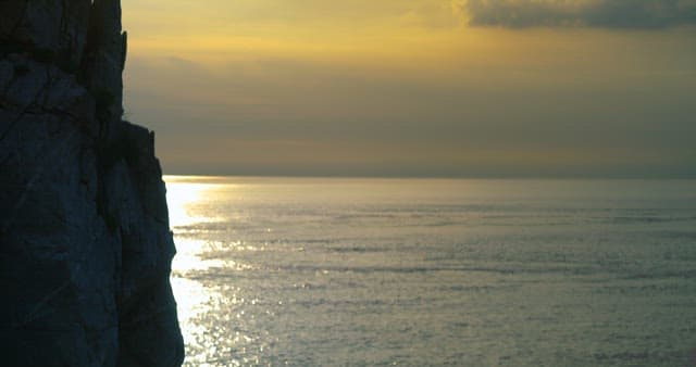 Cliffside View of Sunset over Ocean