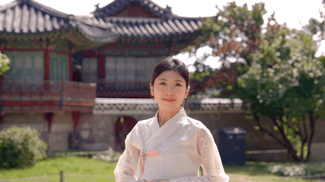Woman in hanbok at a traditional Korean house