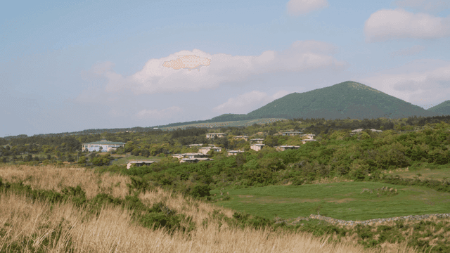 Scenic view of a village near a mountain