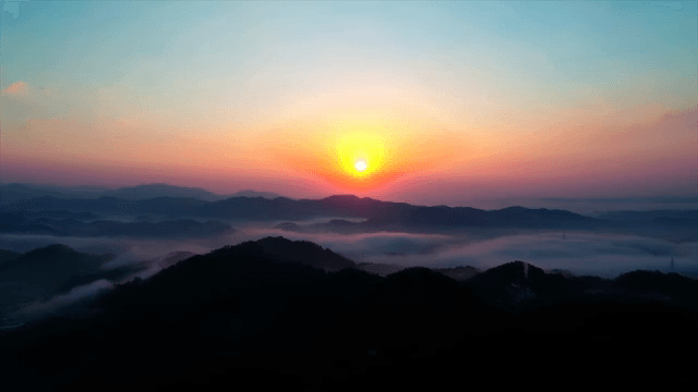 Sunrise over a cloudy mountain landscape
