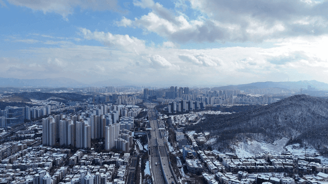 Snow-covered mountains and sprawling cityscape