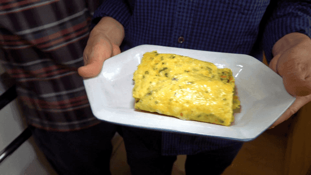 Yellow rolled omelet on plate