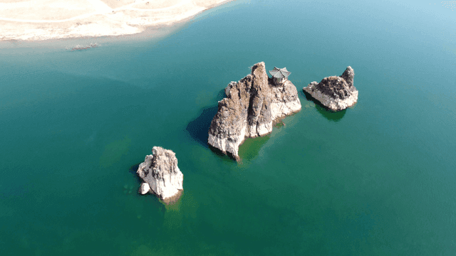 Pavilion by quiet lake with rocks