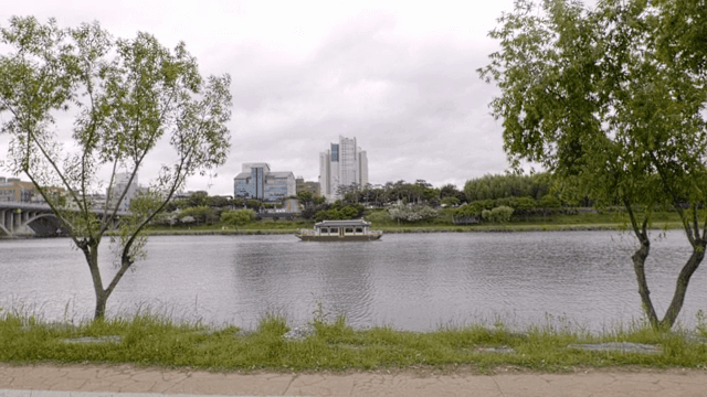 A river with a boat and city skyline