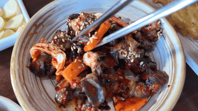 Grilled fish and spicy stir-fried squid with side dishes