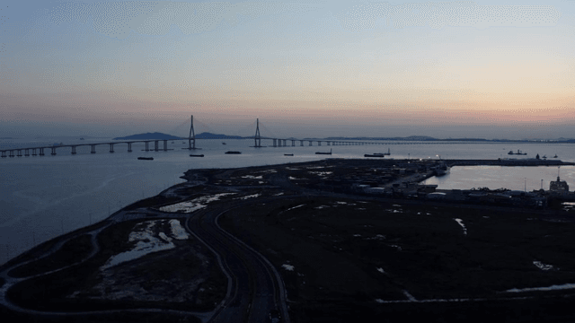 Bridge and harbor over the sea at sunset