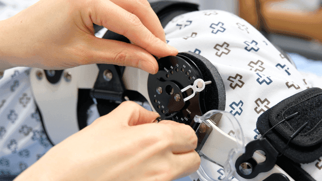 Adjusting a medical brace on a patient's leg
