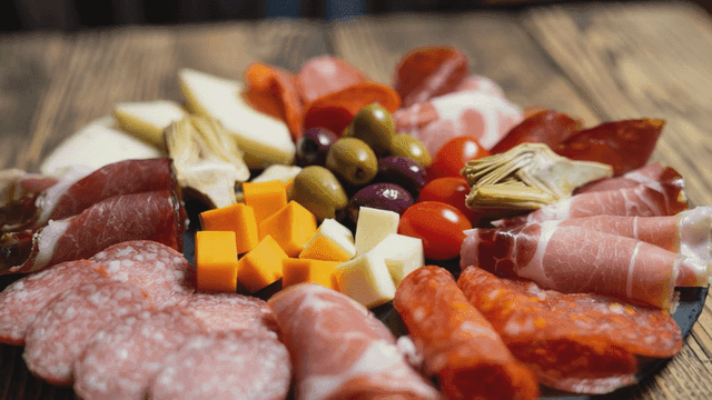 Platter containing various hams, meats, and cheeses