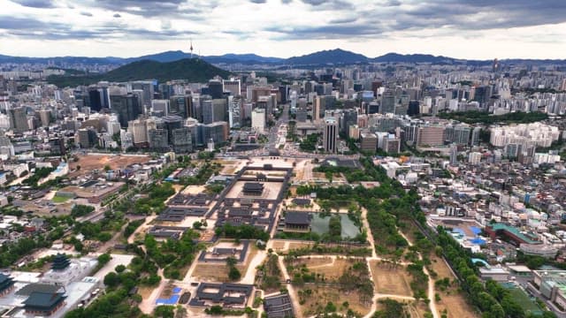 Aerial view of bustling city with traditional palace