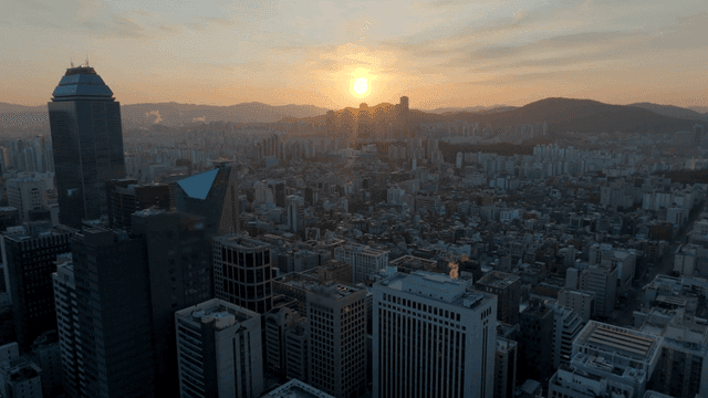 Sunset over a sprawling city skyline