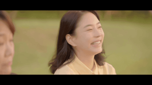 Two women smiling and enjoying conversation outdoors